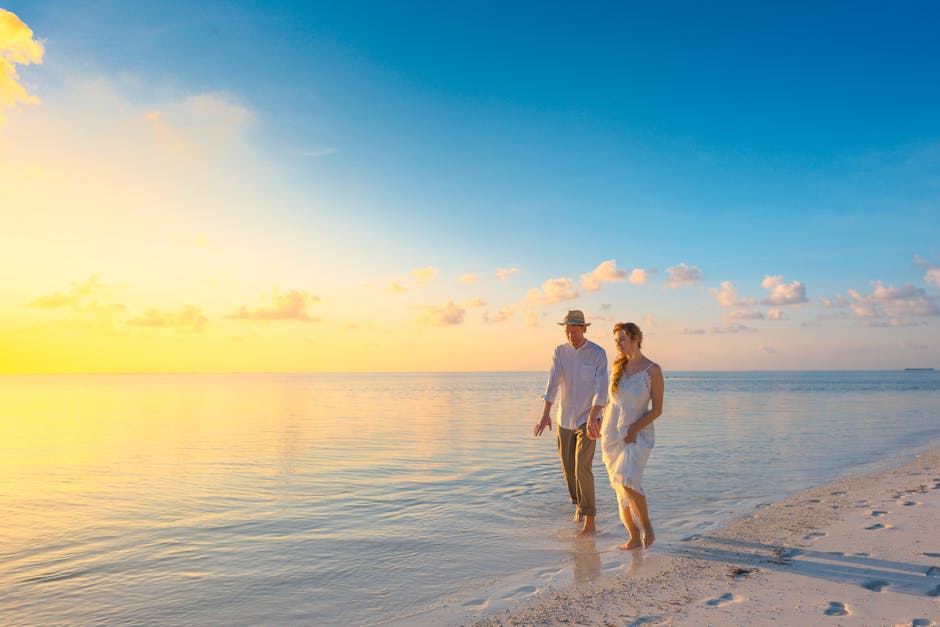 A couple enjoys a romantic walk on a sunny beach in the Maldives at sunrise